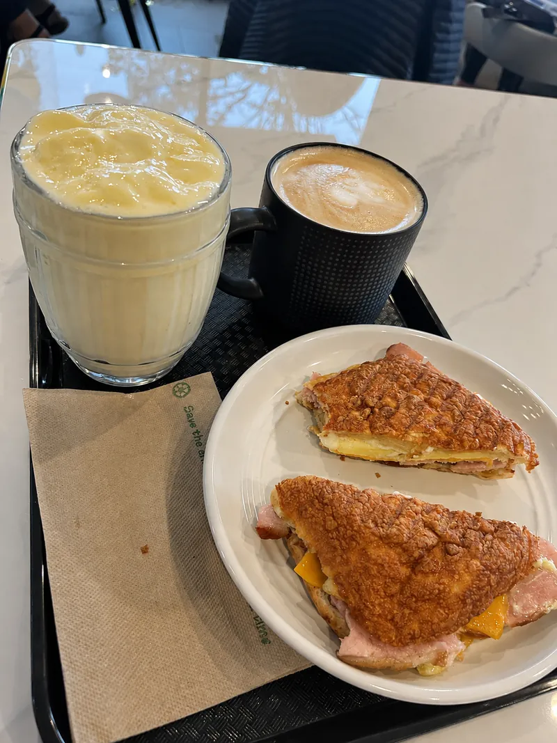 Breakfast sandwich with two drinks