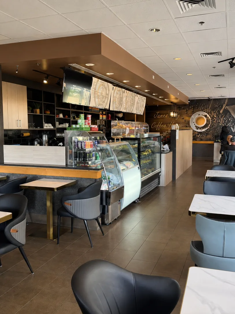 Tables, chairs and the serving counter inside James Bay Coffee House